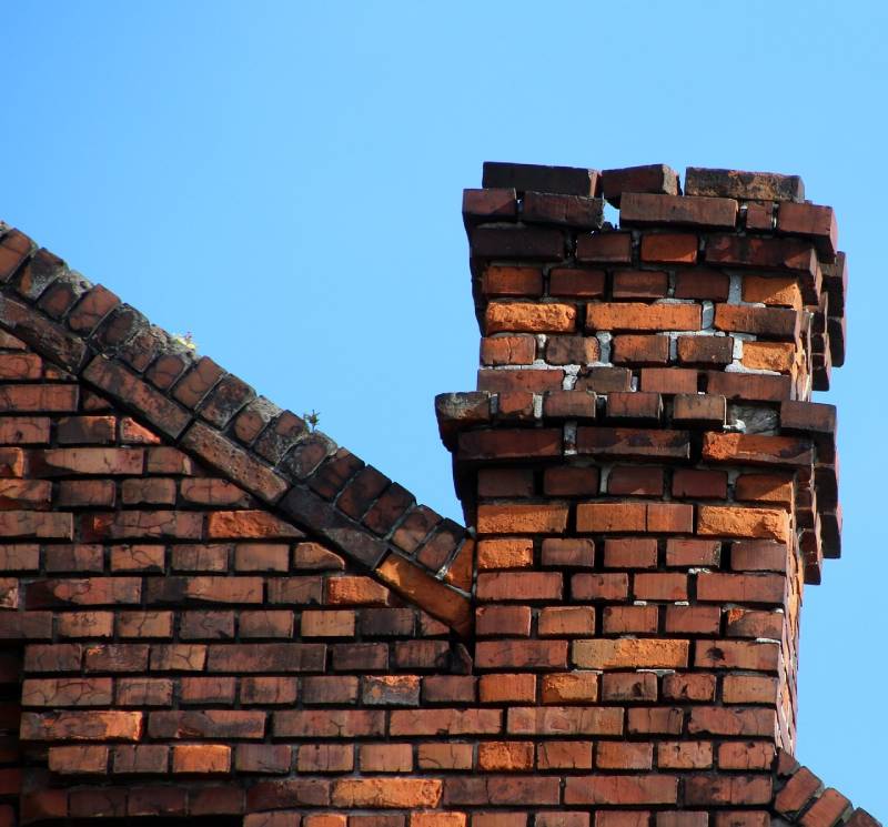 Damaged chimney on an Phoenix home showing cracks and missing mortar